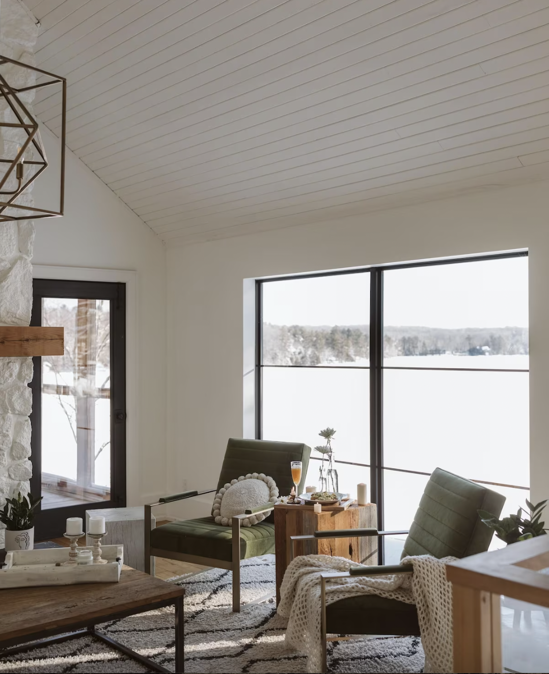 two chairs sit in front of two windows looking out over the lake