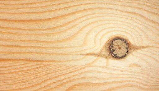 A wood board with a knot in it