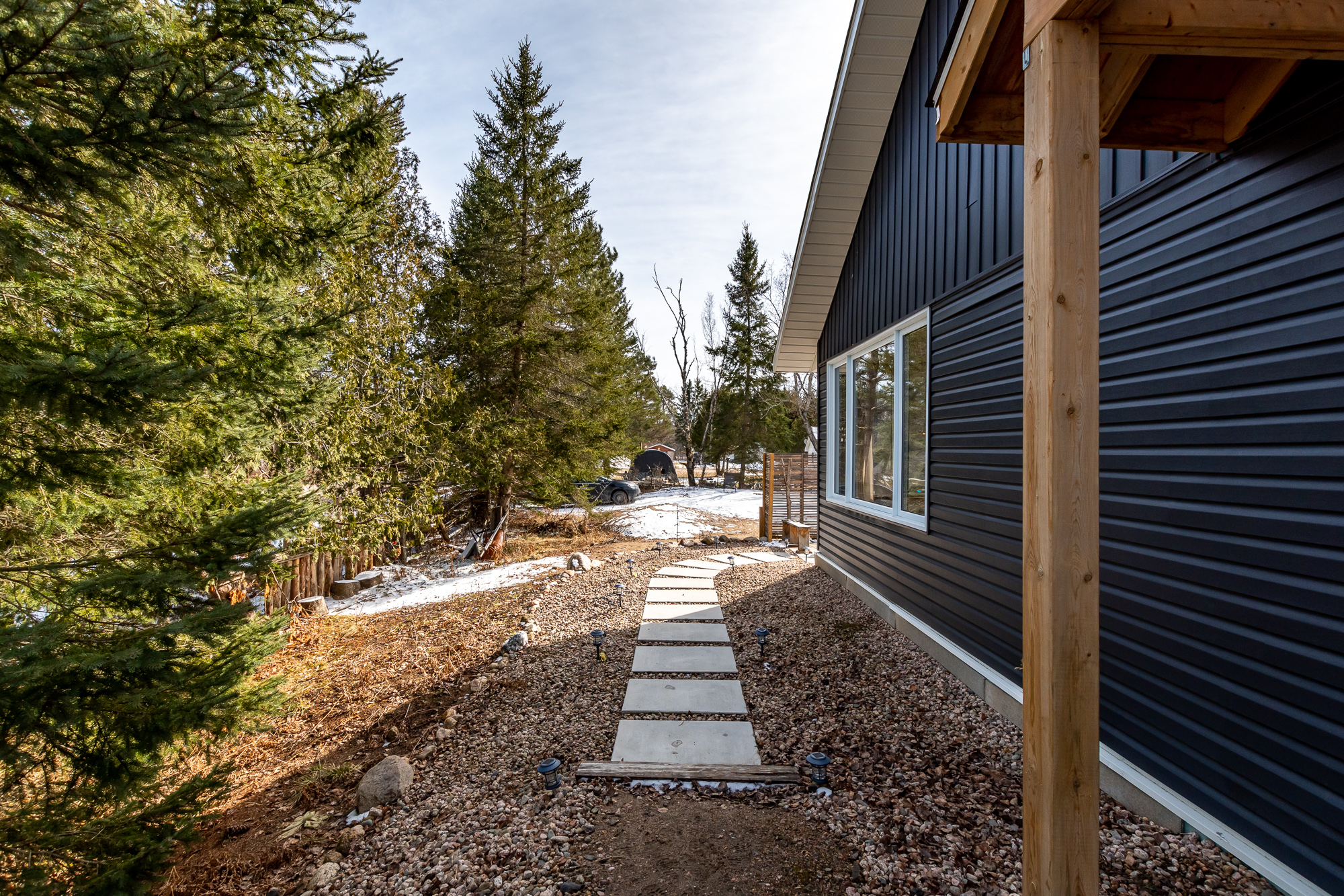 A stone path along the side of the house
