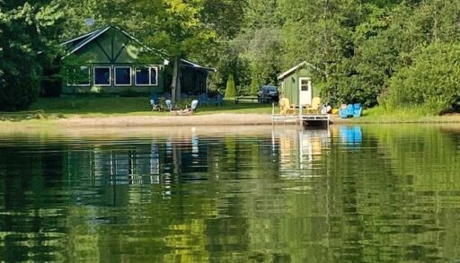 a green waterfront cottage