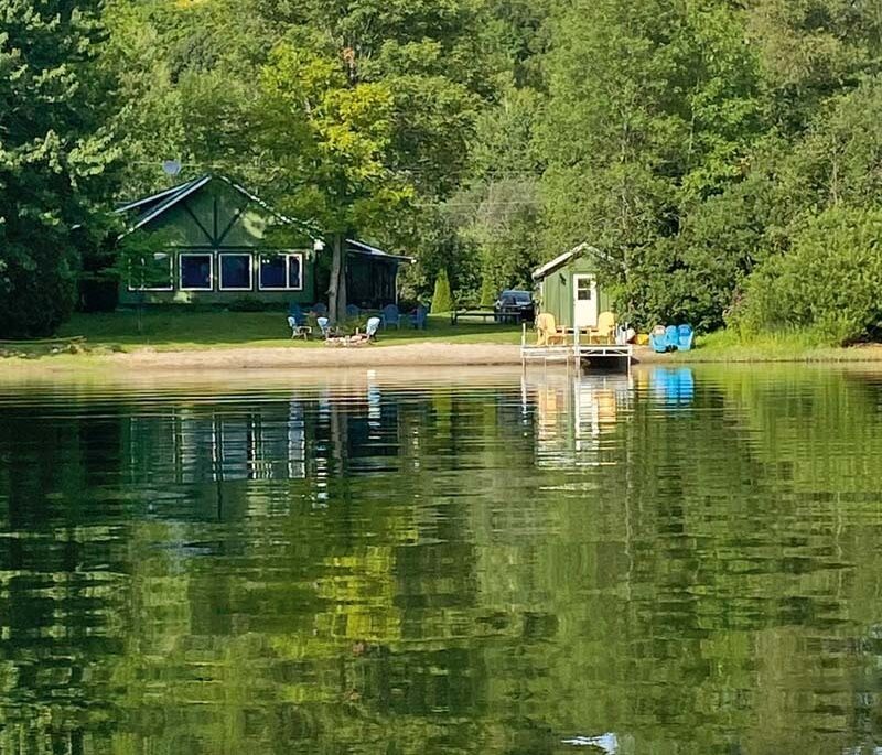 a green waterfront cottage