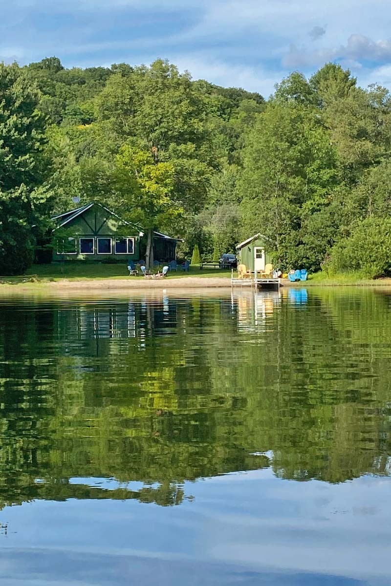 a green waterfront cottage