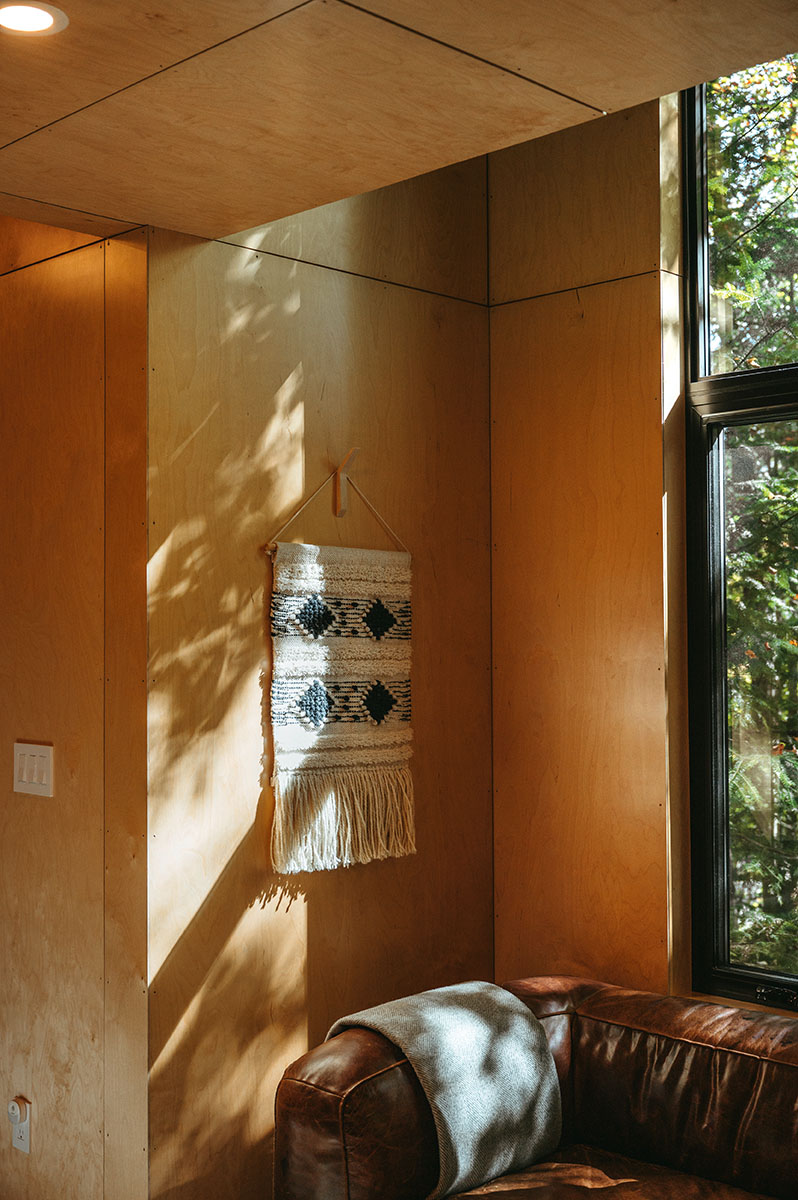 A blue and white macrame hangs on the wall.