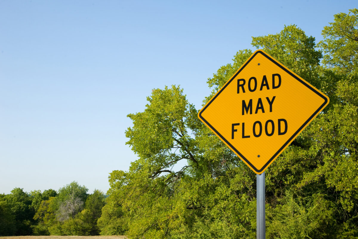 A yellow sign says "road may flood"