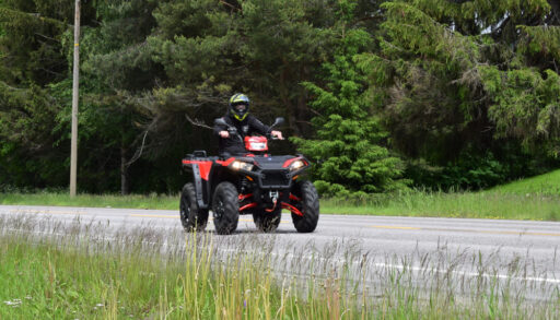 Man driving ATV vehicle on a road