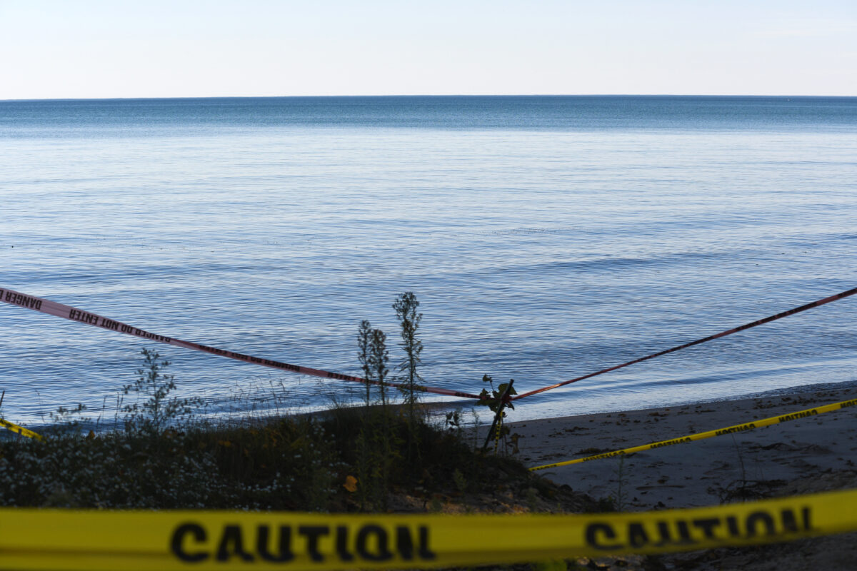 Caution tape blocks off access to a lake