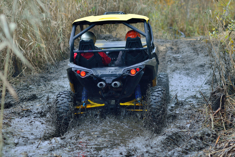 side-by-side, off-road vehicle going through mud