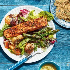 A white plate loaded with salmon and bright vegetables