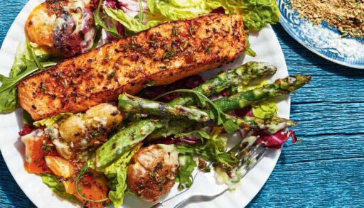 A white plate loaded with salmon and bright vegetables