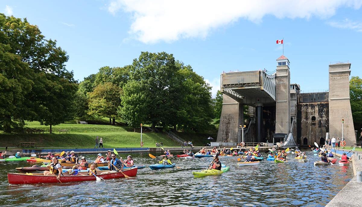 people in kayaks and canoes on the trent-severn waterway in peterborough