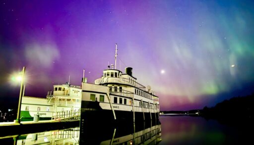 Northern lights appear over two steam boats