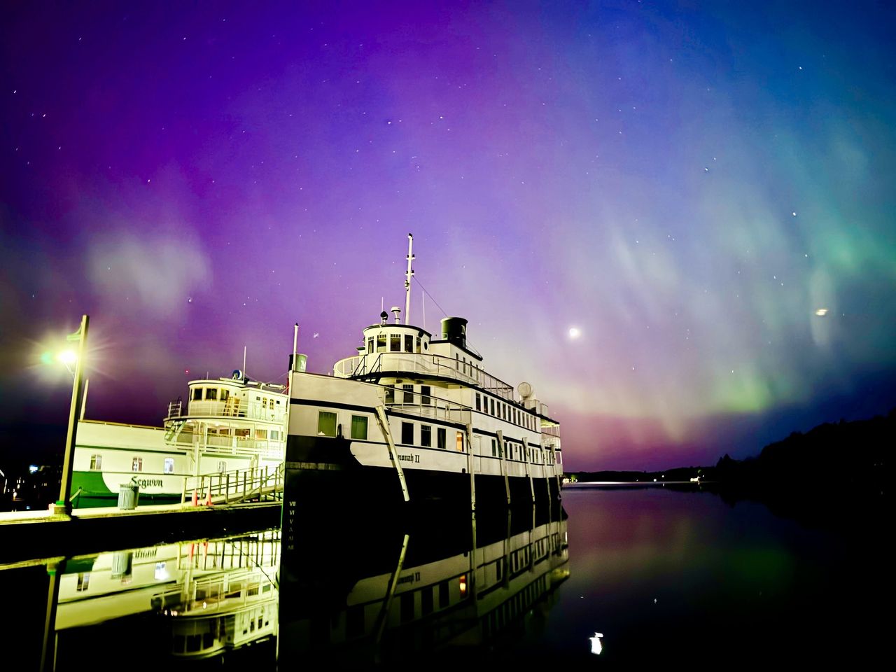 Northern lights appear over two steam boats