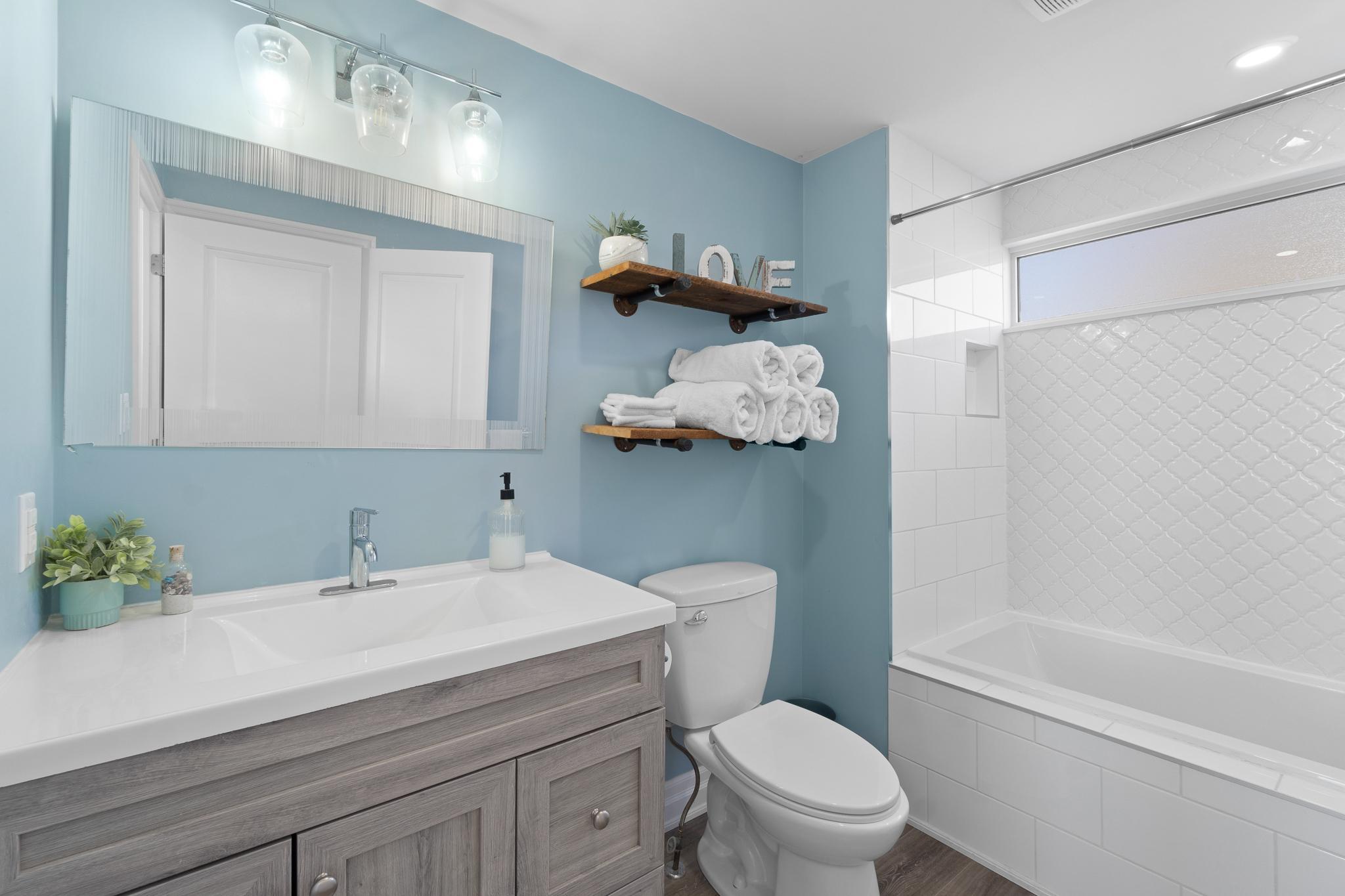 a bathroom with a sink toilet and bath tub