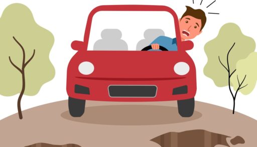 man driving a car over pot holes