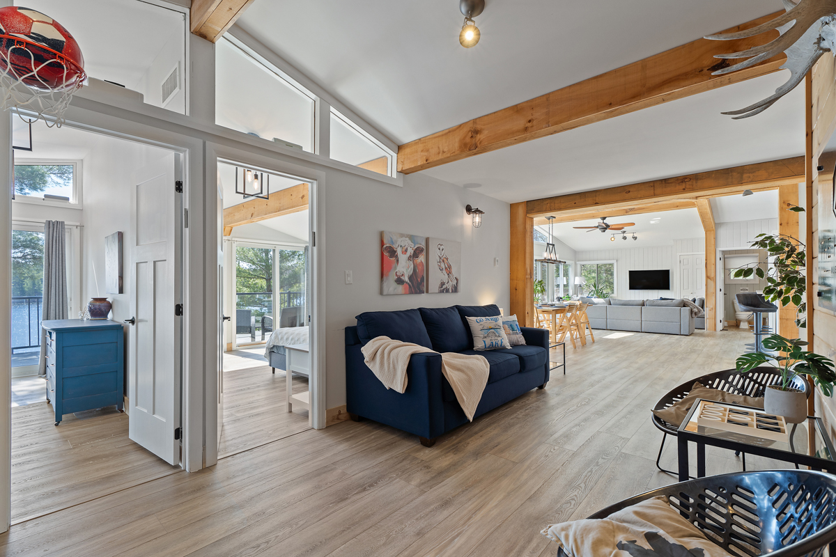 A blue couch in the hall next to an open doorway