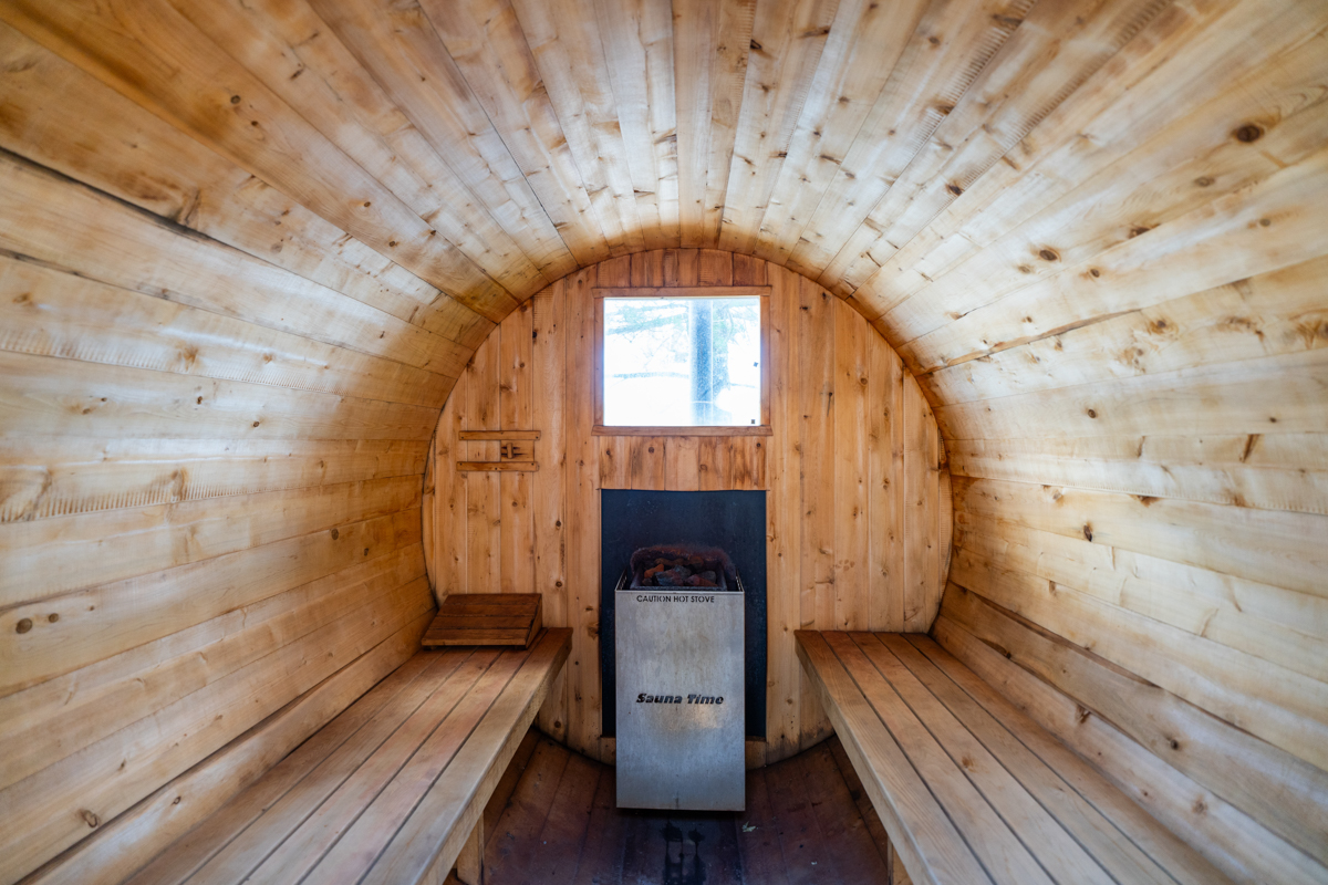Inside the sauna is two wood benches facing each other