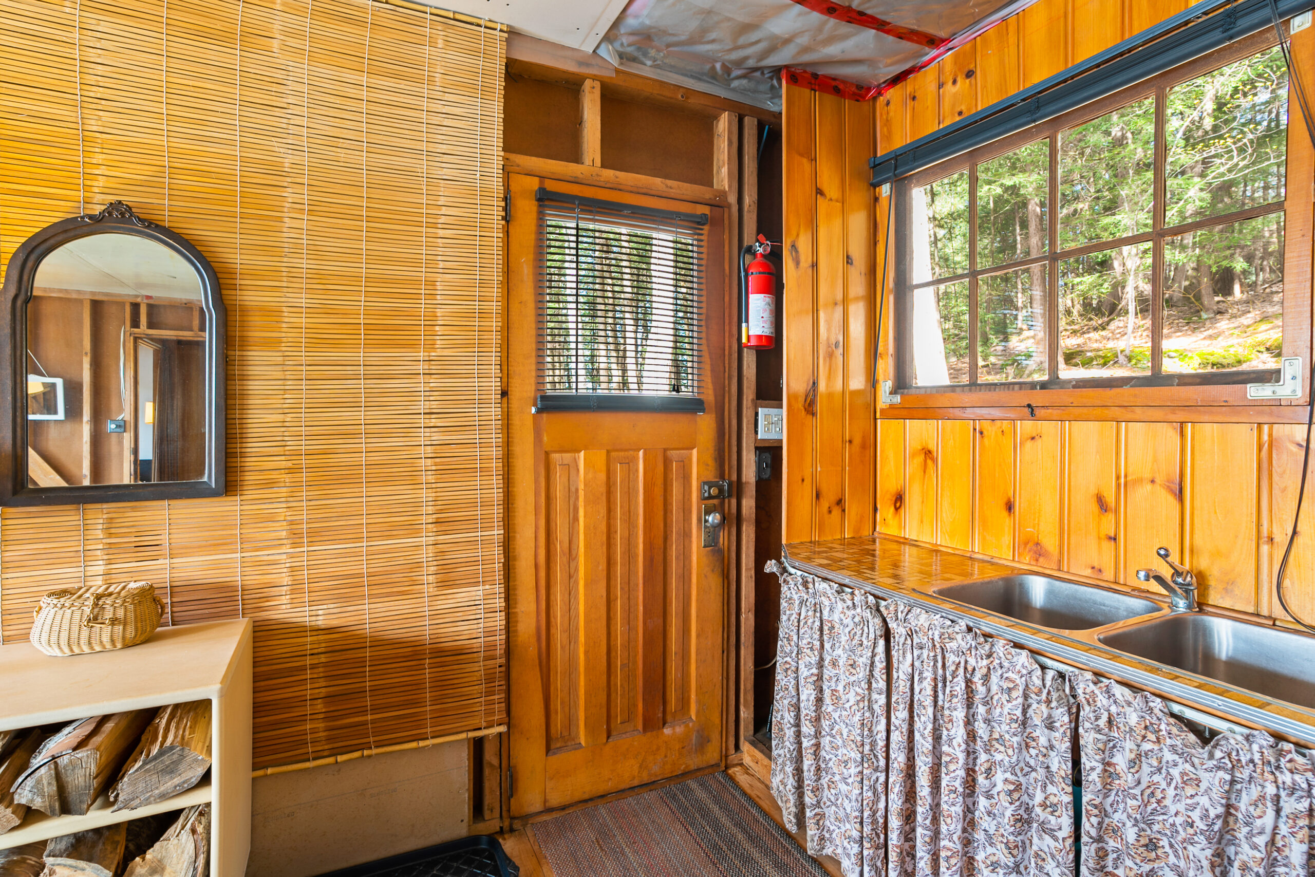 The inside of the cottage has a brown wood front door