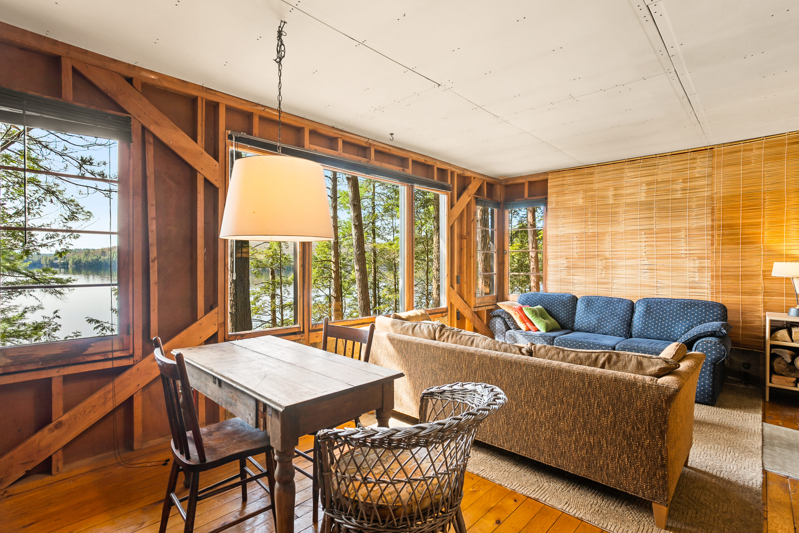 A small brown dining table faces the back of the brown couch