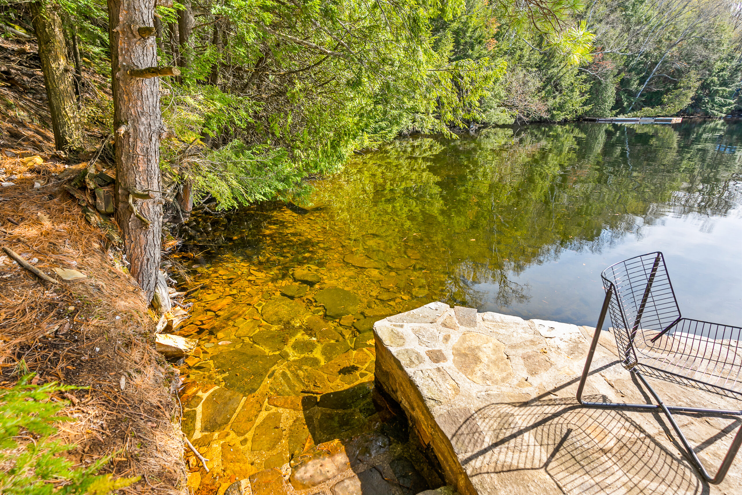 Stone steps lead into the clear, green-tinged water