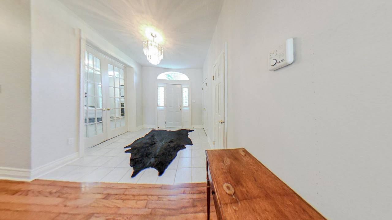 A bright white front entrance with a dark cowskin rug.