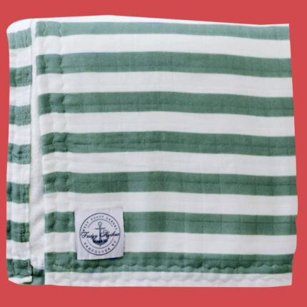 Green and white striped towel on red background