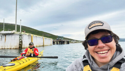 A selfie of Noah and a friend kayaking on the water.