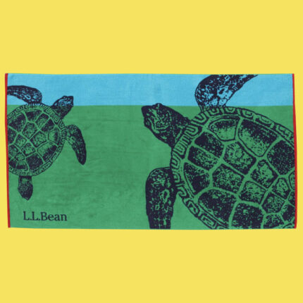 Blue and green beach towel with one large and one small sea turtle