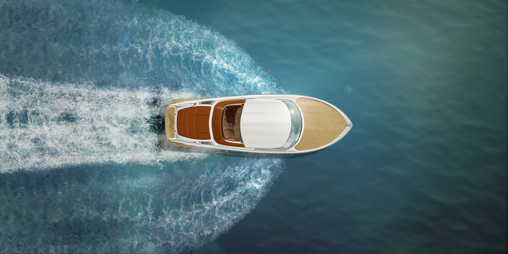 An overhead shot of a boat speeding through the water