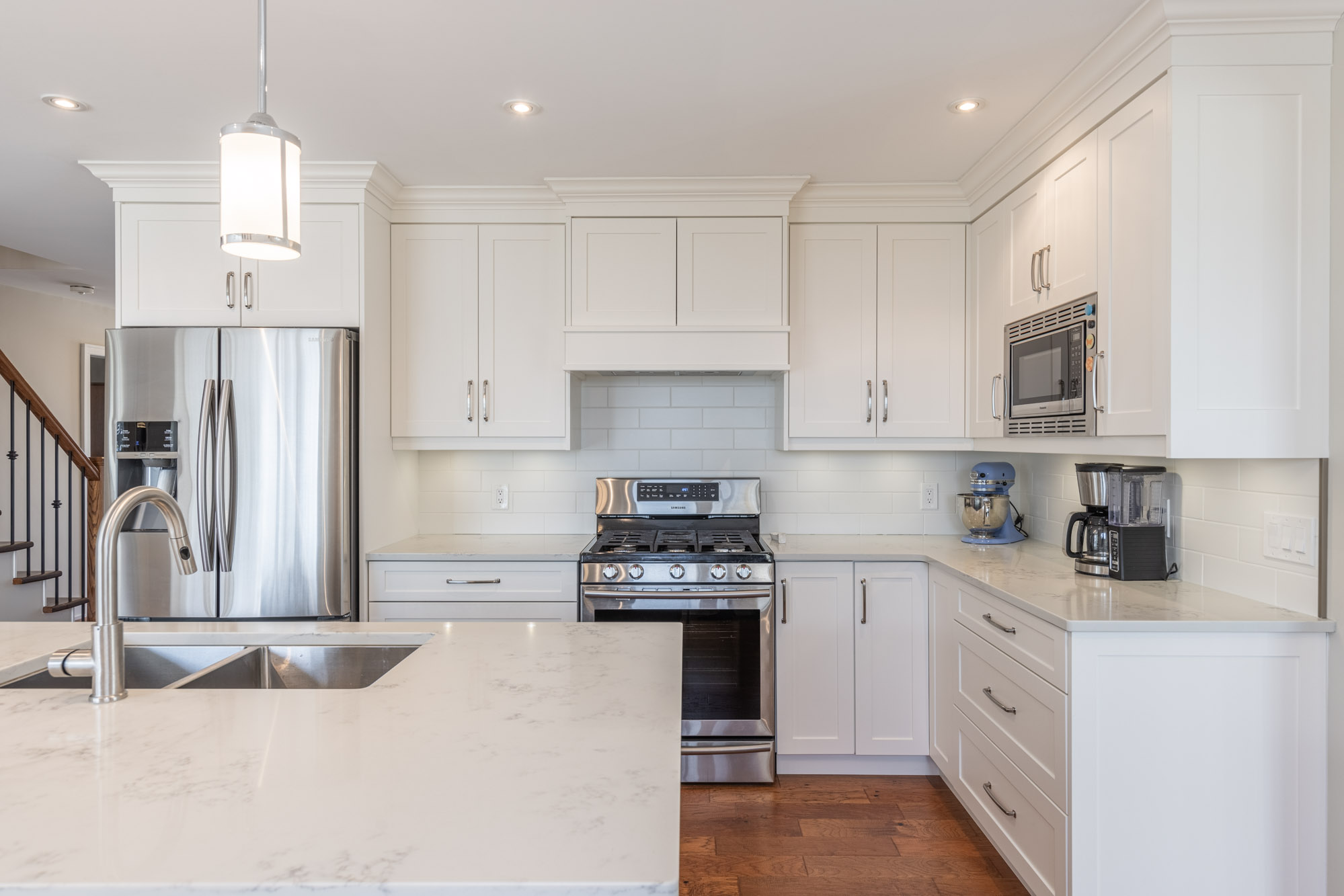 The island faces white cabinets and a stainless steel stove