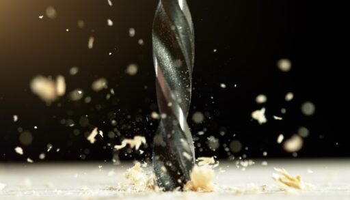 Close up of a drill producing sawdust