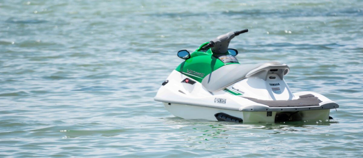 A white and green jet ski on the water