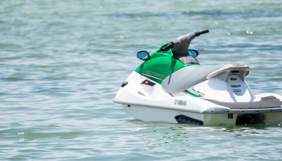 A white and green jet ski on the water