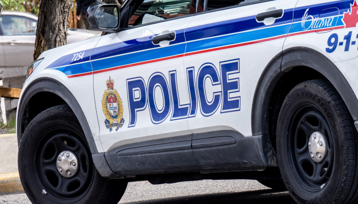 A close up of the side of a white SUV with the words "Police" in blue
