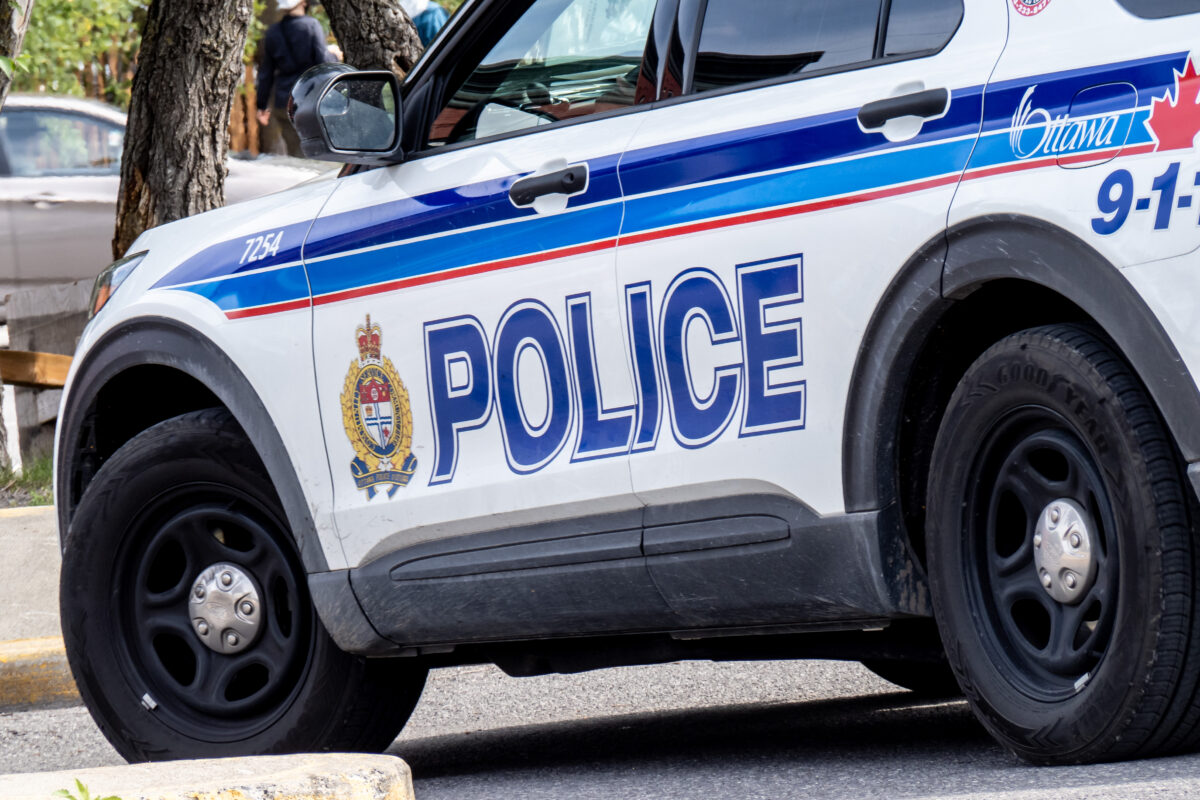 A close up of the side of a white SUV with the words "Police" in blue