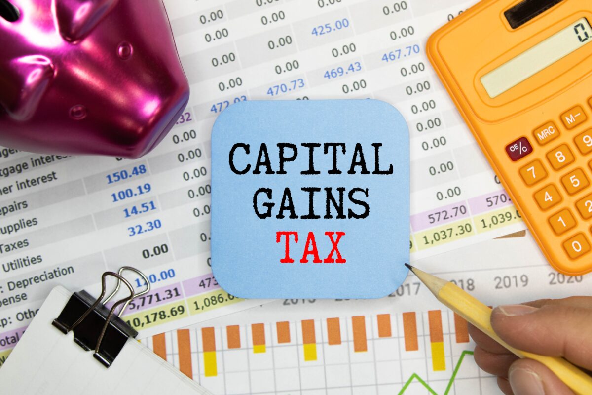 A printed spreadsheet with a blue square on top that reads "Capital gains tax"