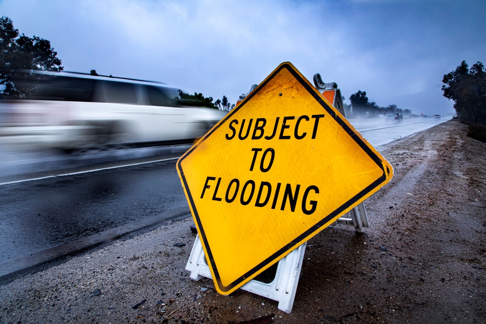 yellow warning sign that says "subject to flooding"