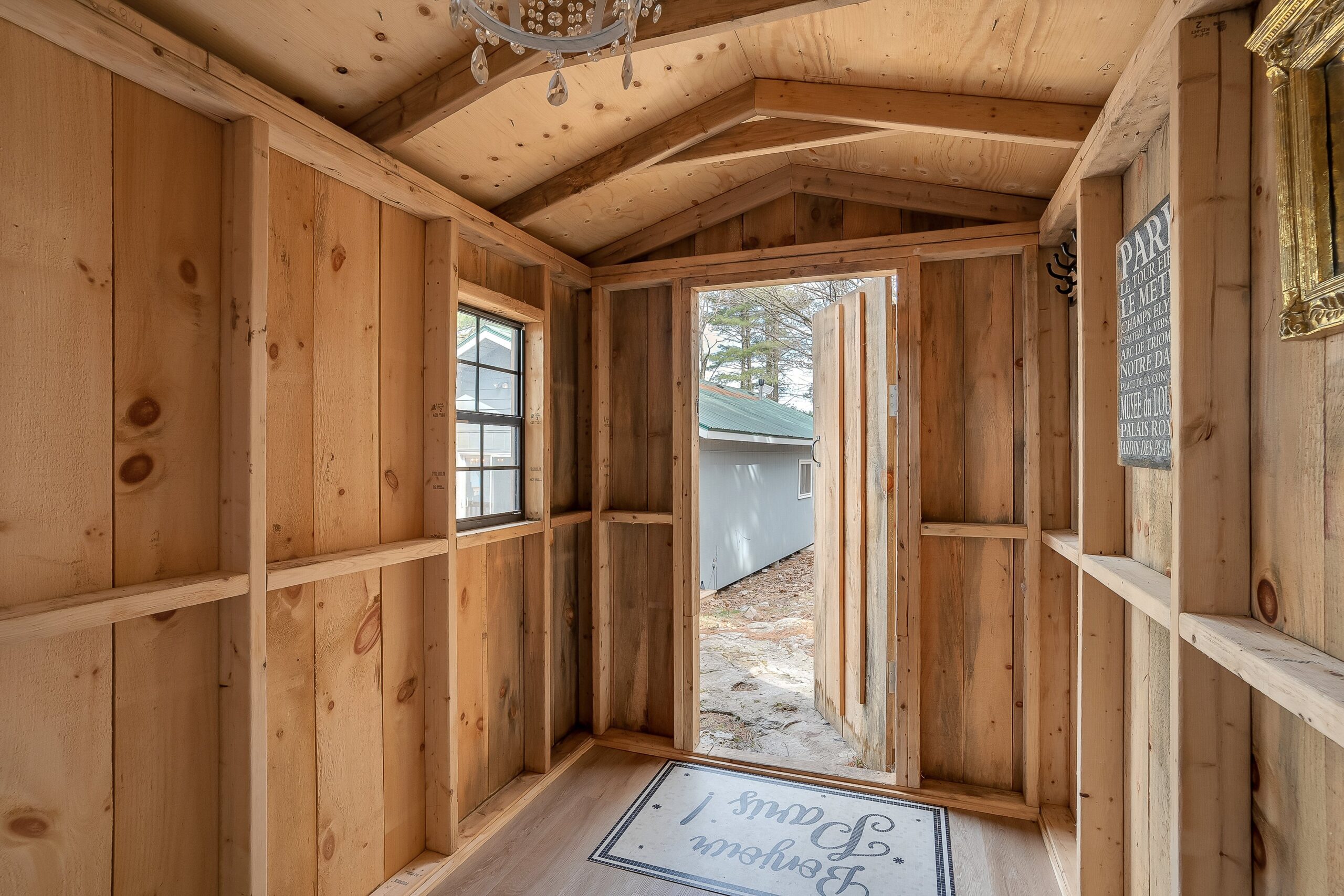 Inside an unfinished cabin with an open doorway