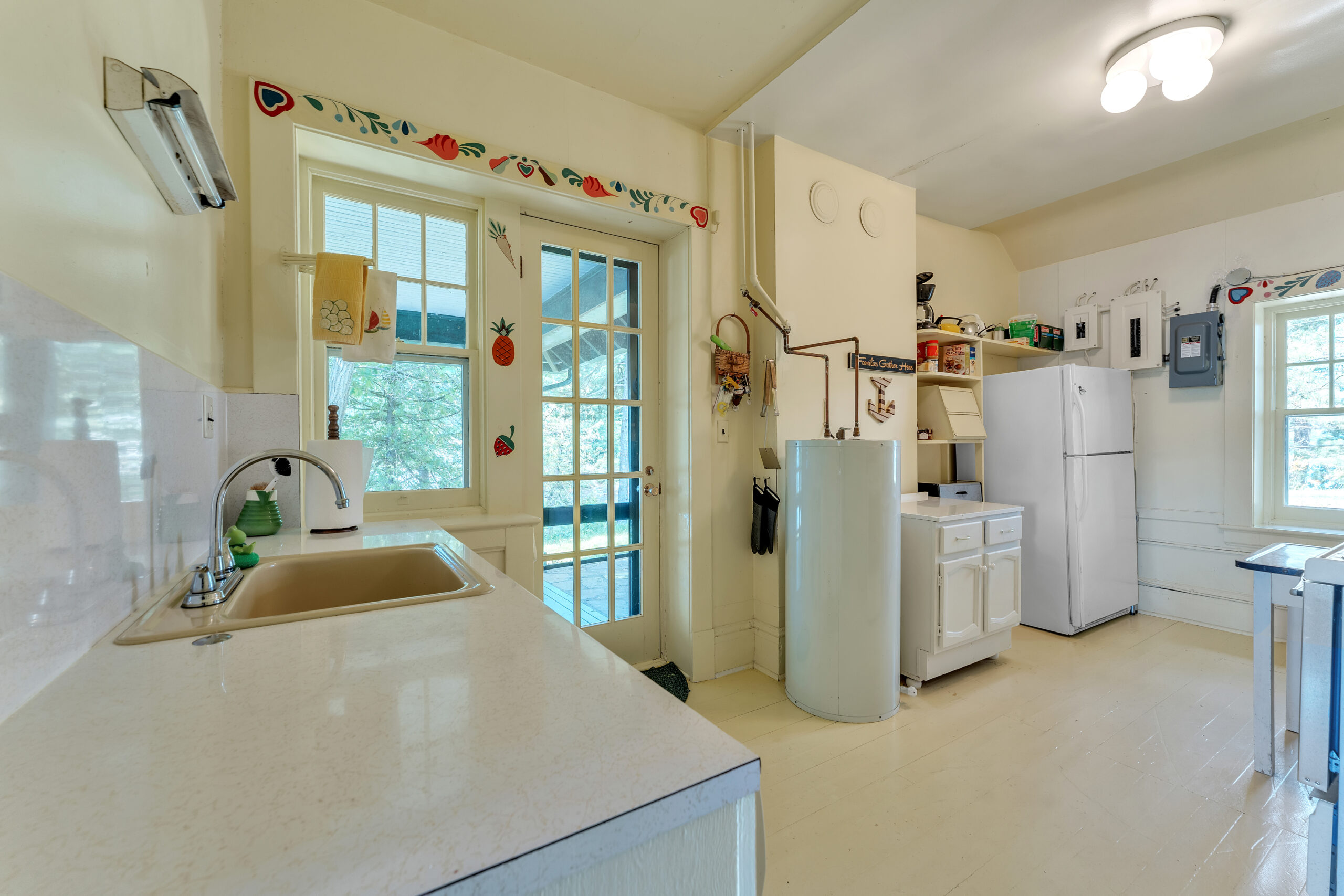 A beige kitchen with white French doors