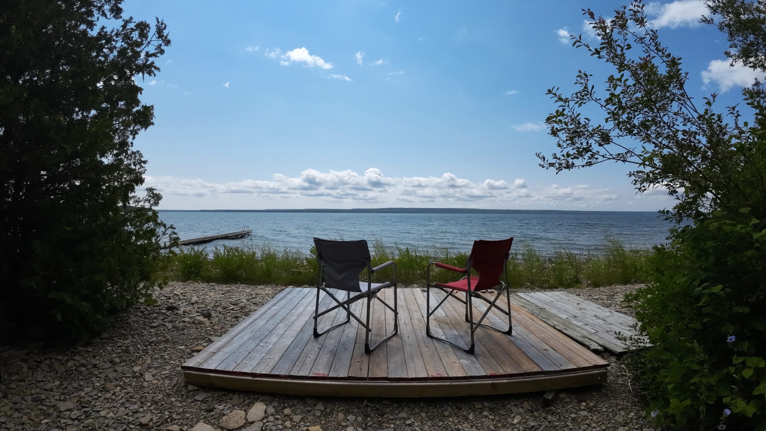 two chairs by the water