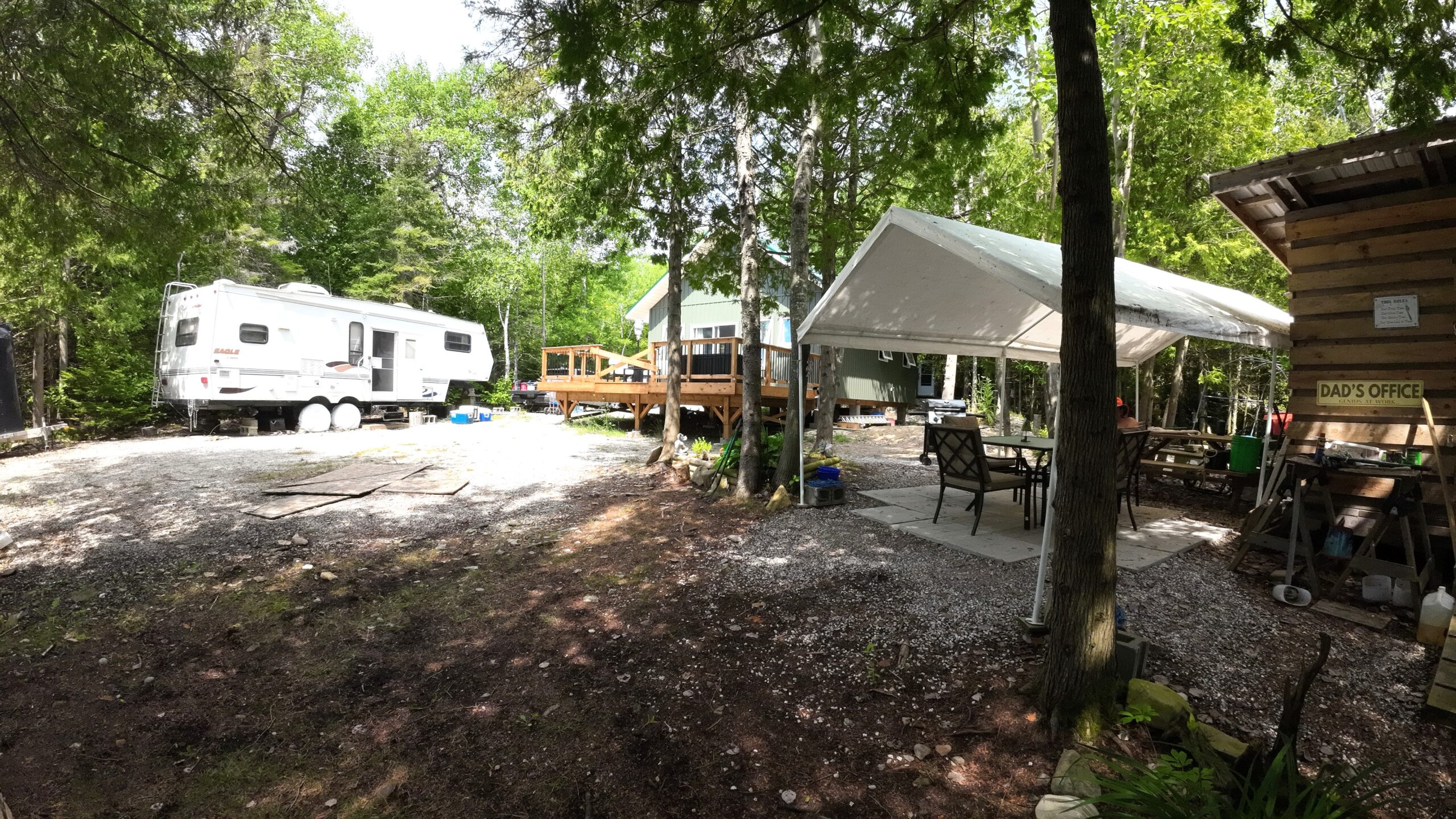 a property with a tent, trailer and cottage