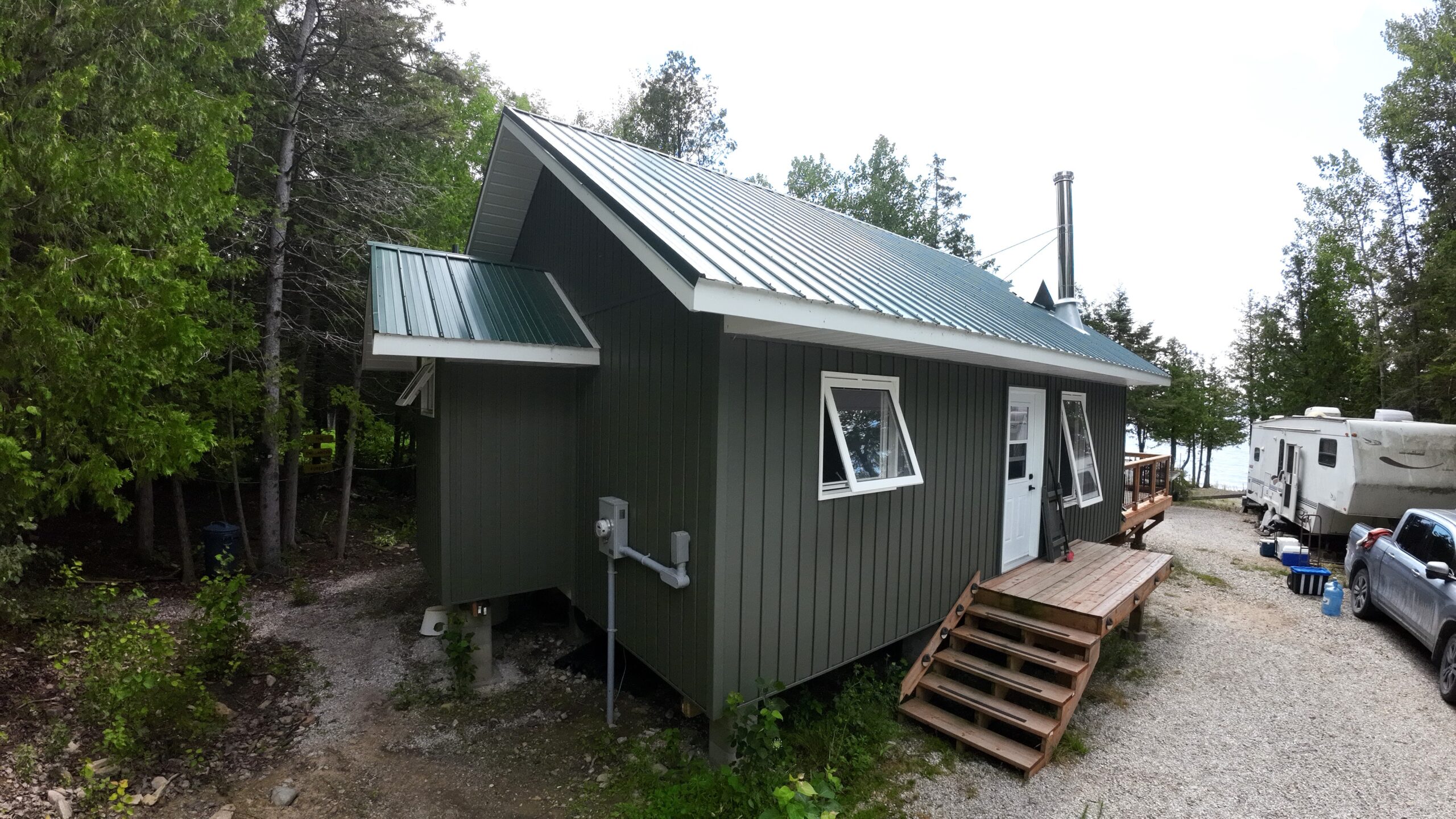 the exterior of a green cottage