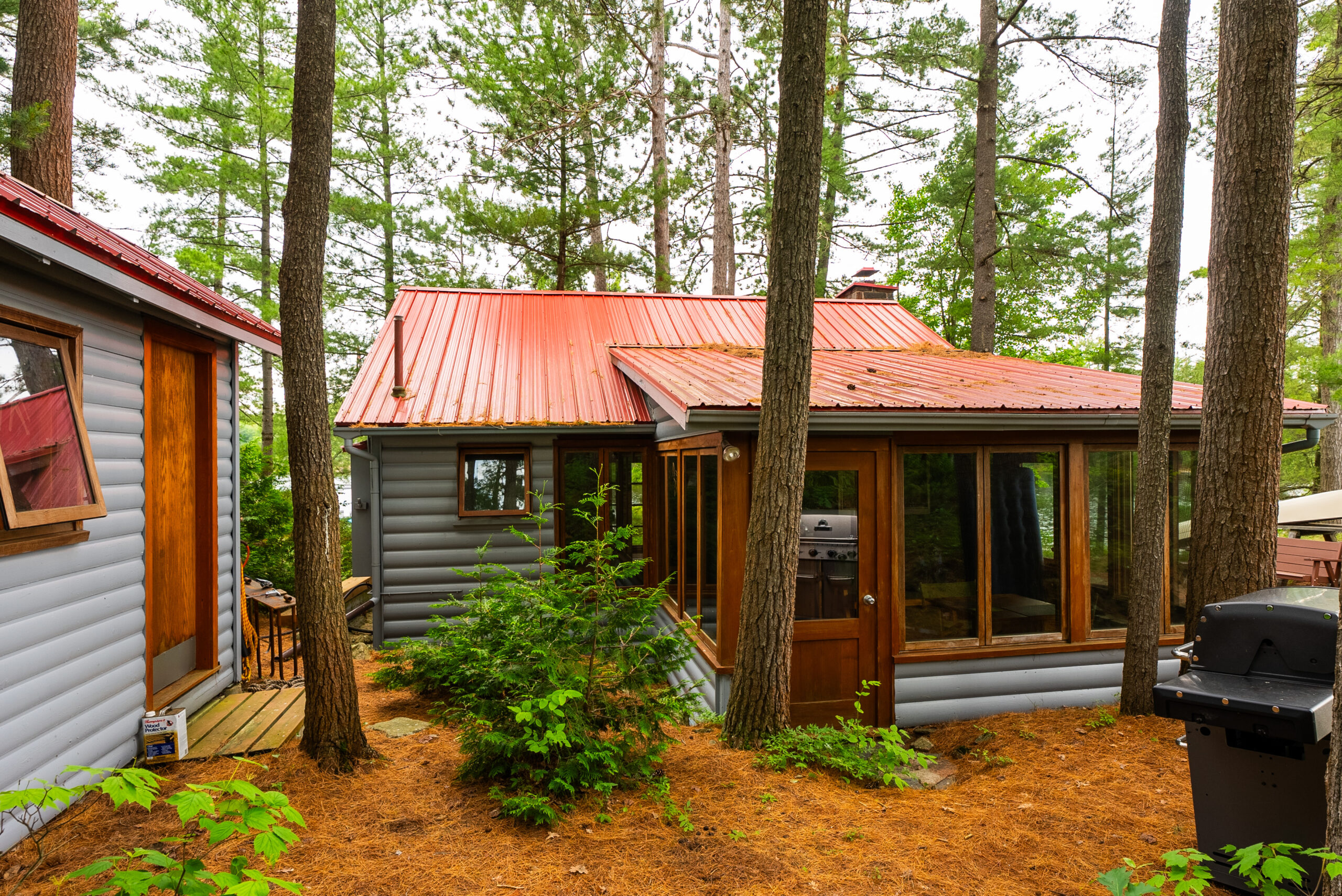 A grey cottage with a sunroom