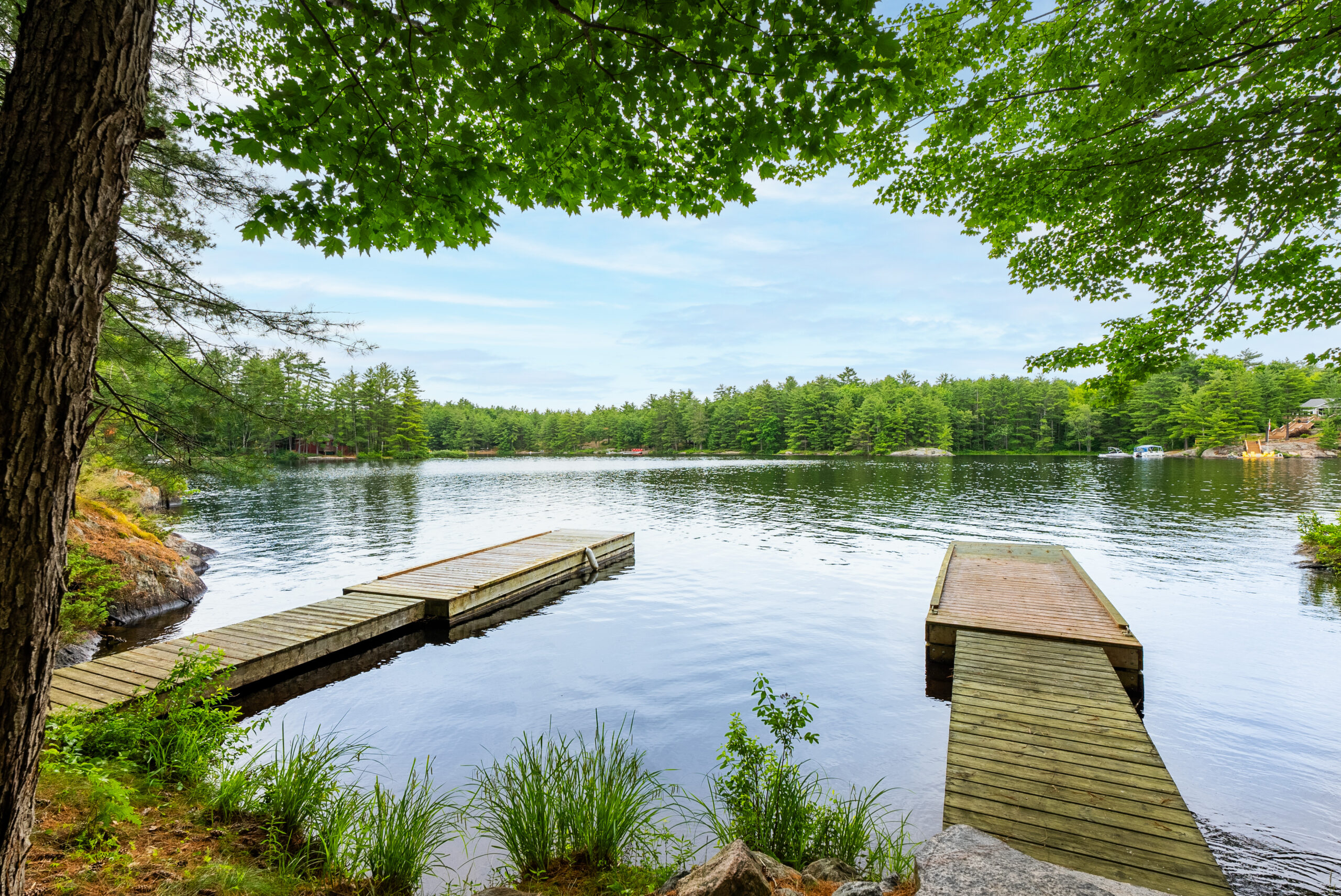 Two wood docks jut out into the blue water