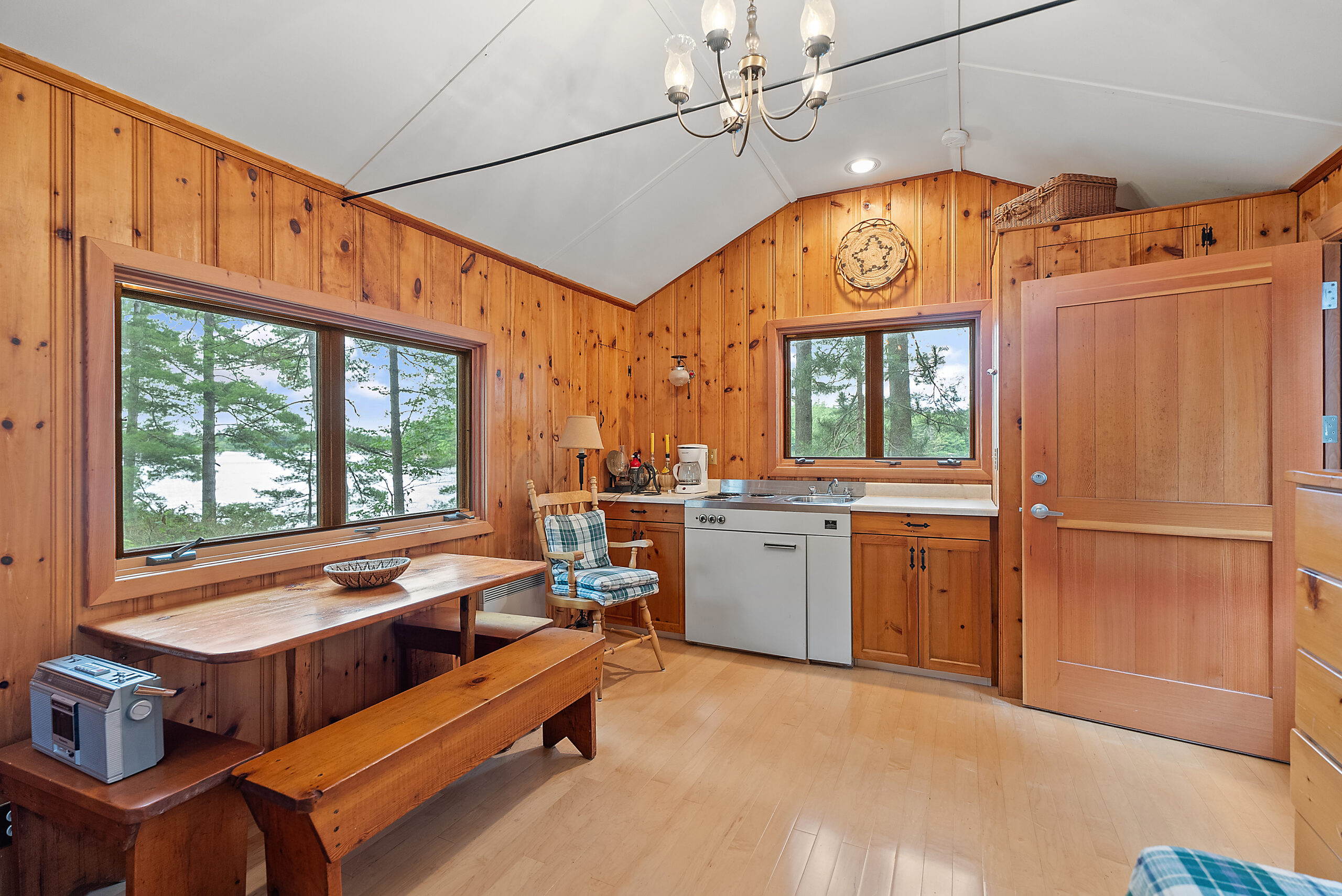 A kitchenette lines the wall of a red wood room