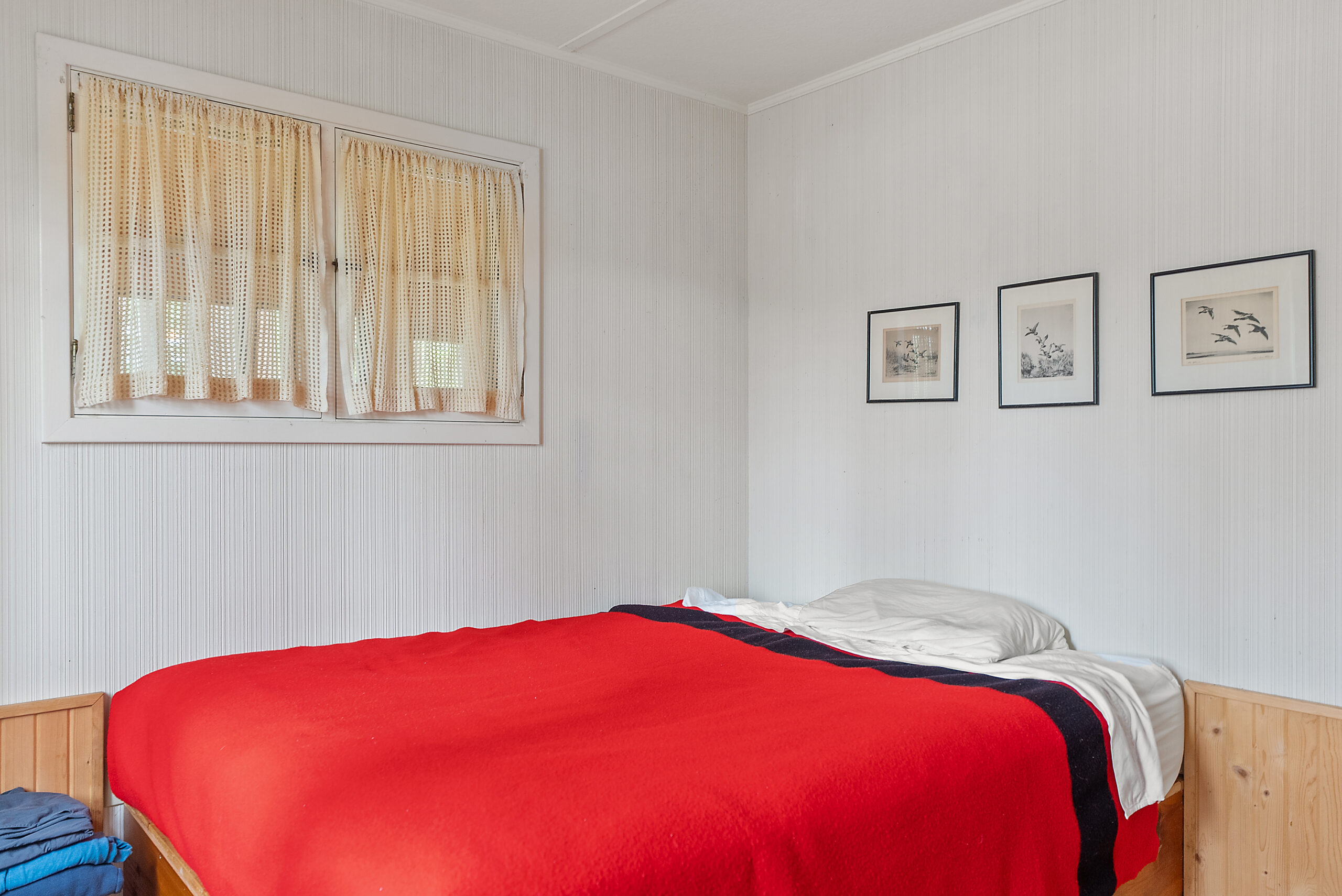 A red bed in a white room