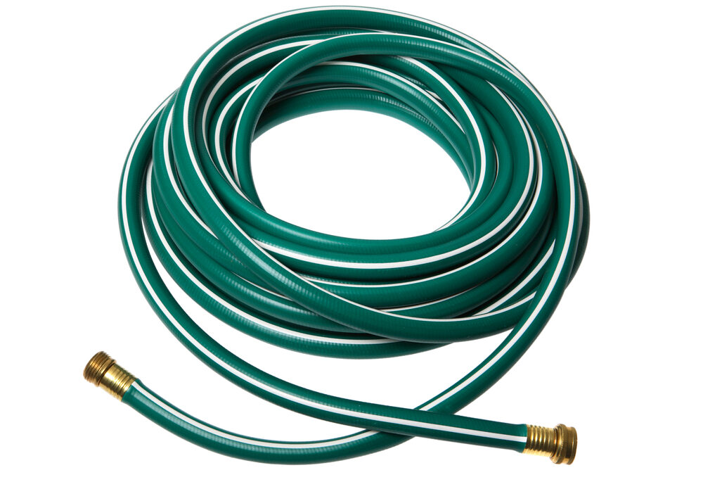 A green garden hose against a white background