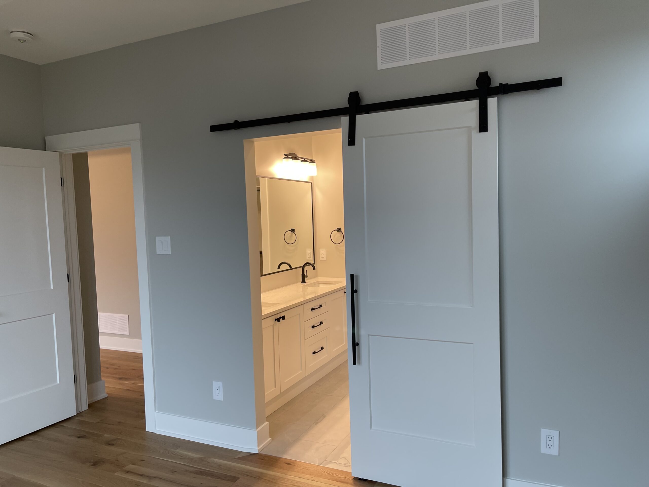 A white sliding barn door is partially open