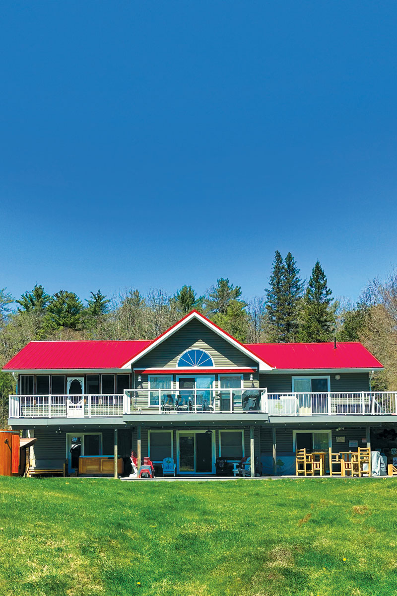 a portrait photo of a cottage with a red roof