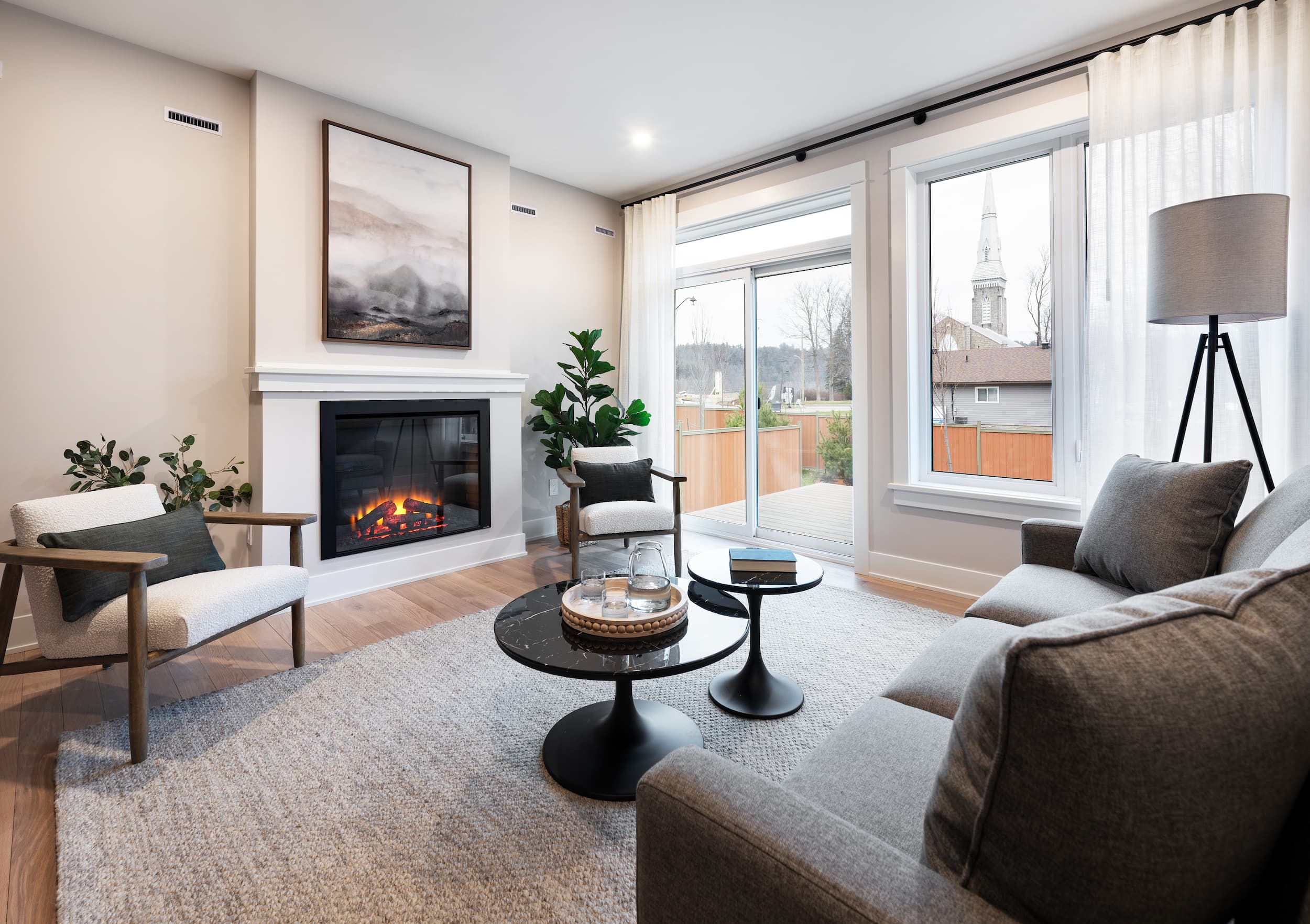 A couch faces a coffee table and a fireplace