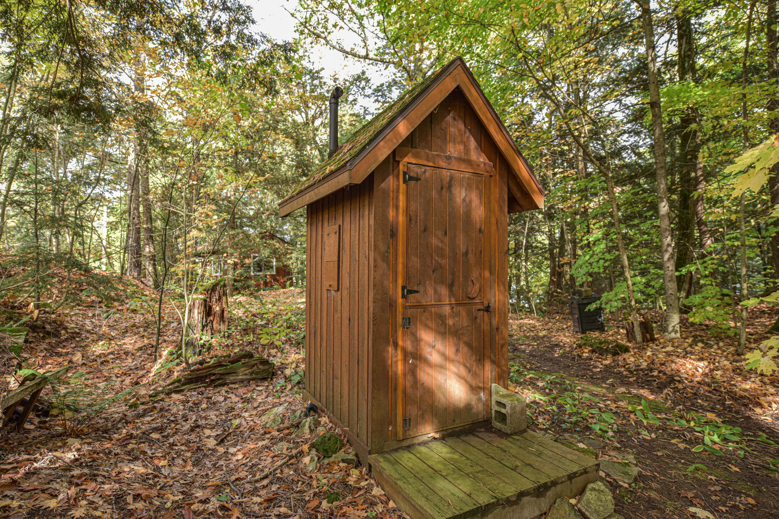 A wood outhouse in the forest